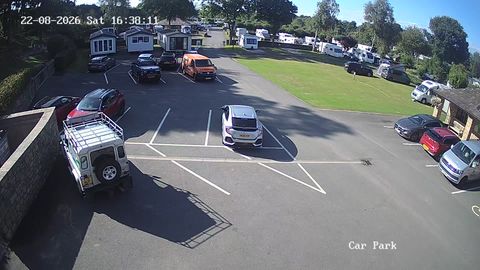 Online stream showing a wide shot of a parking lot and free spaces